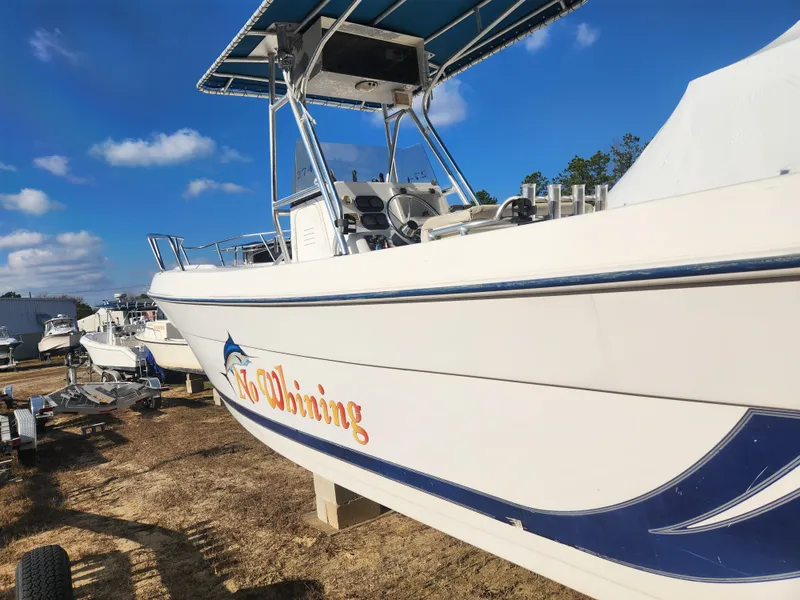 Slide: The Image of 2001 Cobia 274 Center Console boat on display under blue sky. - 7
