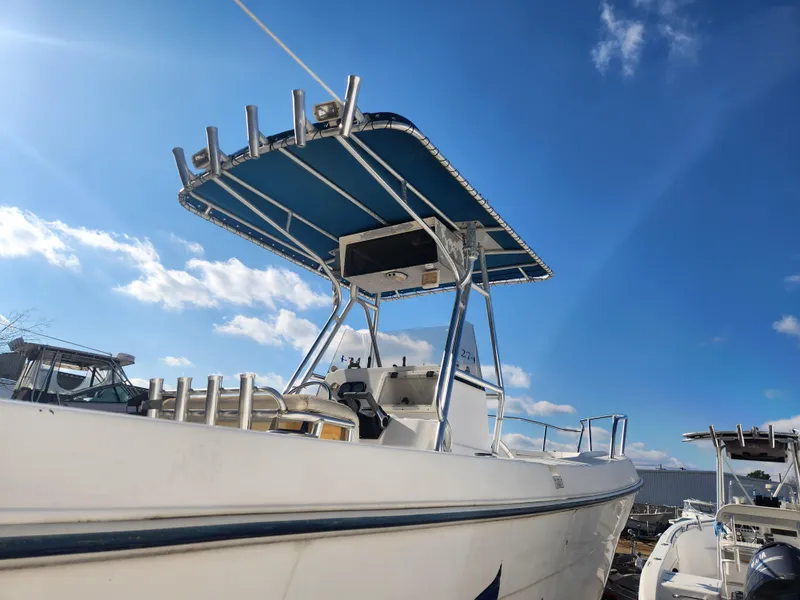 Slide: The Image of 2001 Cobia 274 Center Console boat with T-top under clear blue sky. - 8