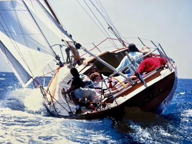 Slide: The Image of Sailing on a 1961 Lapworth 40 yacht, crew navigating through ocean waves. - 10