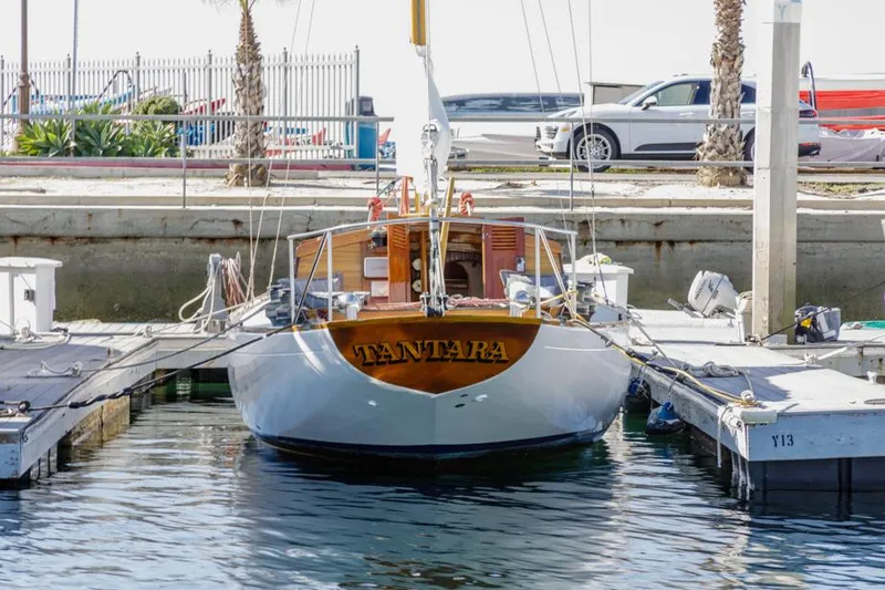 Slide: The Image of Classic 1961 Lapworth 40 sailboat docked at marina, named "Tantara." - 11
