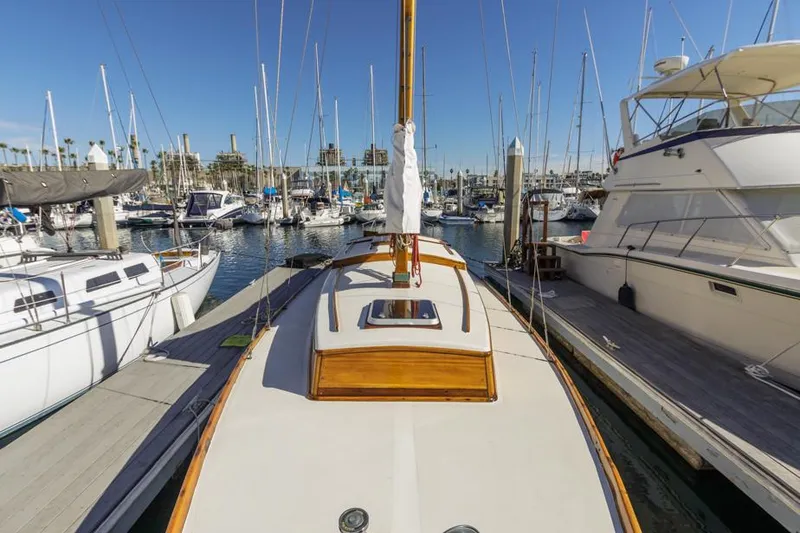 Slide: The Image of Sailboat docked in marina, Lapworth 40, 1961 model, surrounded by other boats. - 18