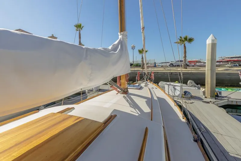 Slide: The Image of 1961 Lapworth 40 sailboat deck with wooden accents, docked at marina. - 22
