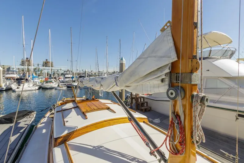 Slide: The Image of 1961 Lapworth 40 sailboat docked in a marina under clear blue skies. - 25