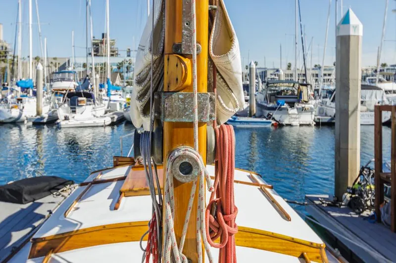 Slide: The Image of 1961 Lapworth 40 sailboat docked in a marina, surrounded by other boats. - 26