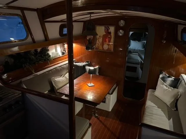 Slide: The Image of Cozy interior of a 1961 Lapworth 40 sailboat with wooden furnishings and ambient lighting. - 44