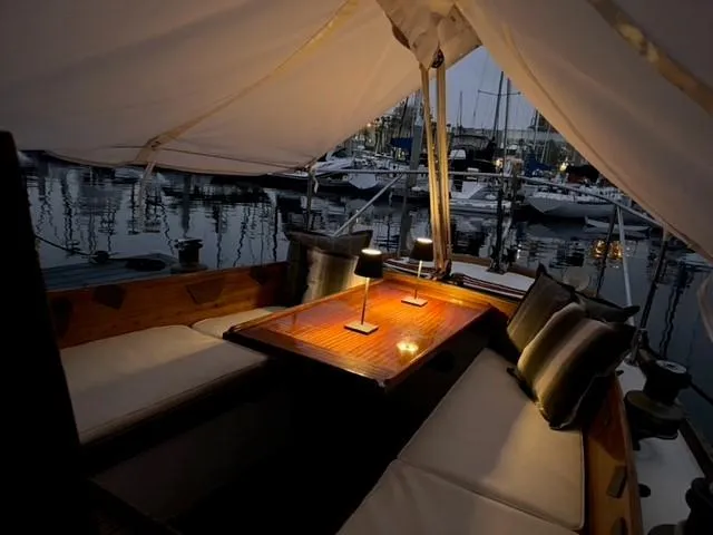 Slide: The Image of Cozy interior of a 1961 Lapworth 40 sailboat with elegant seating and ambient lighting. - 45