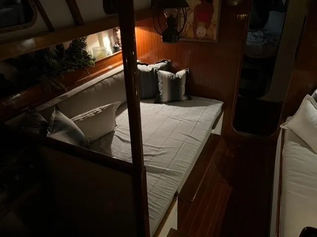 Slide: The Image of Cozy interior of a 1961 Lapworth 40 sailboat with cushioned seating and warm lighting. - 47