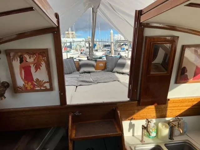 Slide: The Image of Interior view of a 1961 Lapworth 40 sailboat with cozy seating and nautical decor. - 8