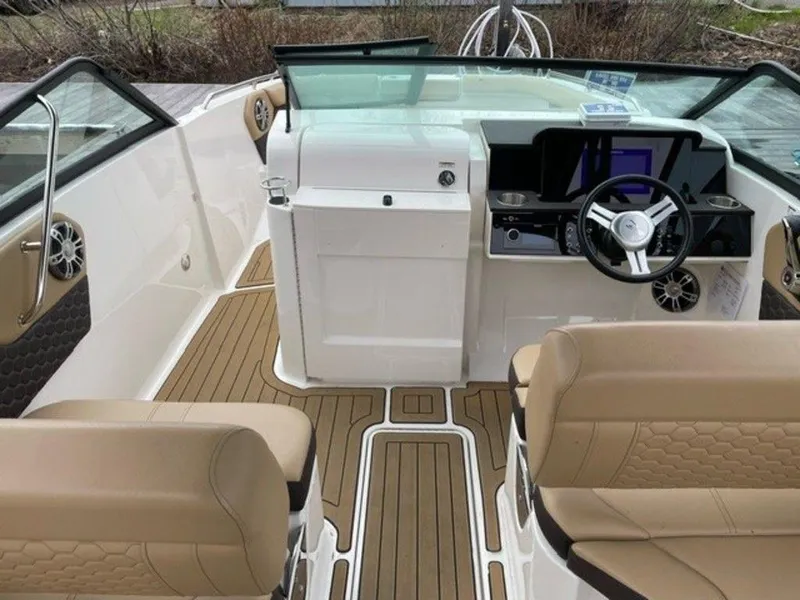 Slide: The Image of 2023 Sea Ray 250 SDX boat interior with tan seats and modern dashboard. - 4