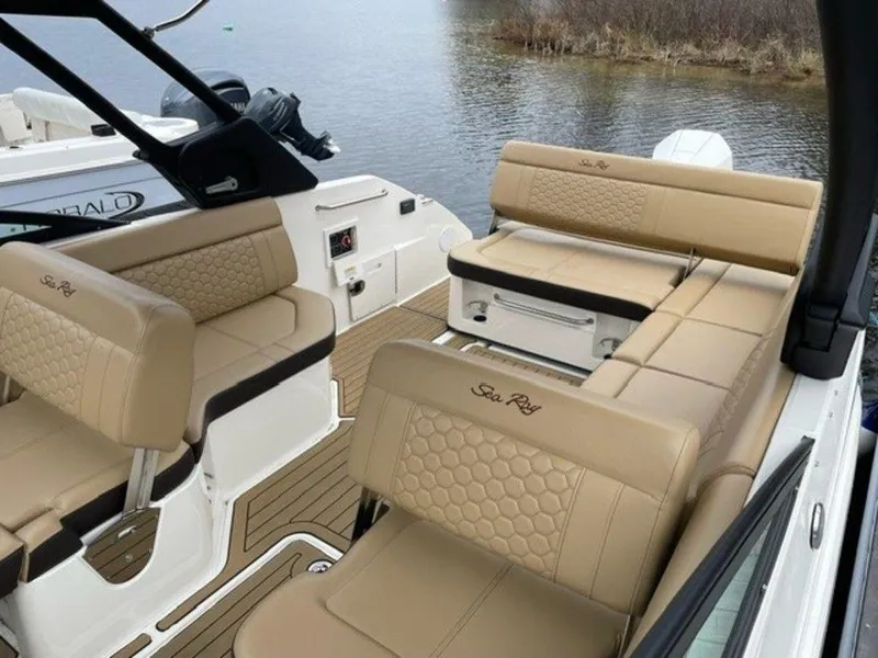 Slide: The Image of 2023 Sea Ray 250 SDX boat interior with tan leather seating and lake view. - 5