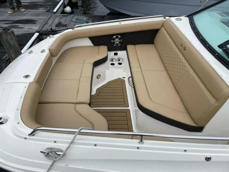 Slide: The Image of 2023 Sea Ray 250 SDX boat with spacious tan seating and teak flooring. - 6