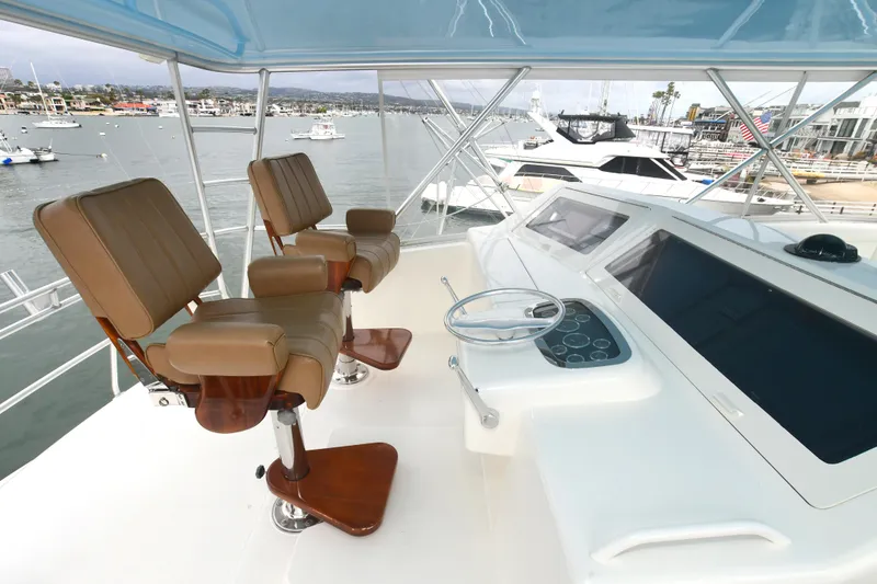 Slide: The Image of Flybridge of a 2000 Viking 65 Convertible yacht with two captain's chairs. - 11