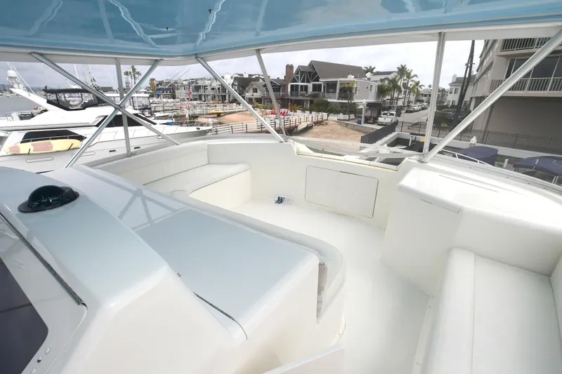 Slide: The Image of Flybridge seating area on a 2000 Viking 65 Convertible yacht, docked at a marina. - 13