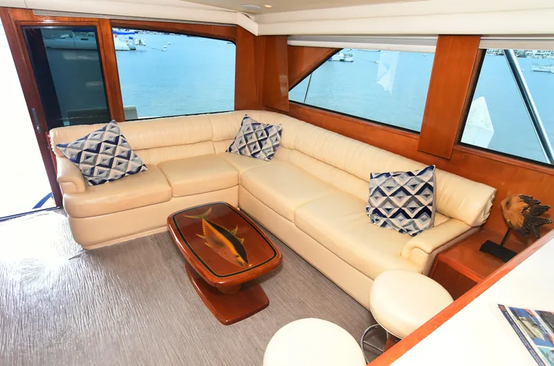 Slide: The Image of Luxurious interior of 2000 Viking 65 Convertible yacht with cream leather sofa and ocean view. - 16