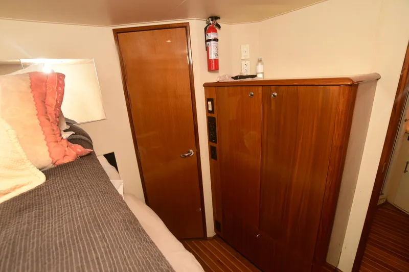 Slide: The Image of Interior cabin of a 2000 Viking 65 Convertible yacht with wooden door and cabinet. - 18
