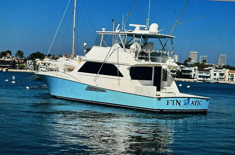 Slide: The Image of Viking 65 Convertible yacht, 2000 model, on calm water with cityscape background. - 3