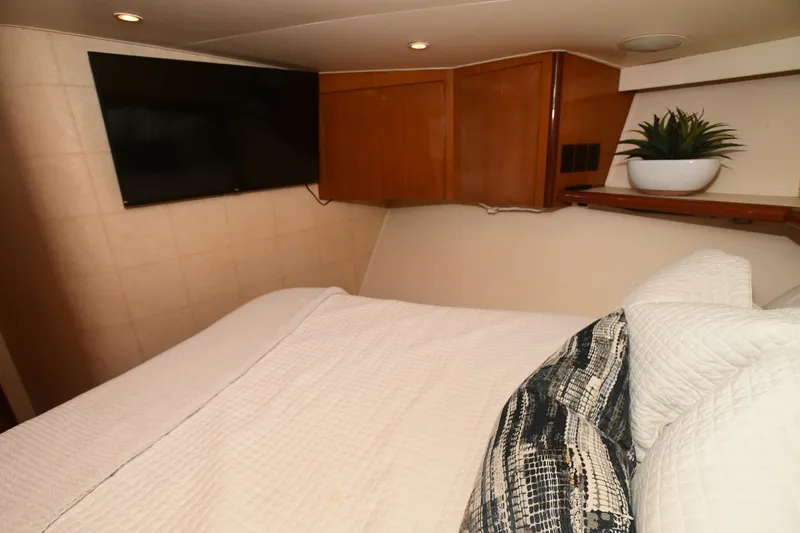 Slide: The Image of Cozy bedroom in 2000 Viking 65 Convertible yacht with TV and plant. - 33
