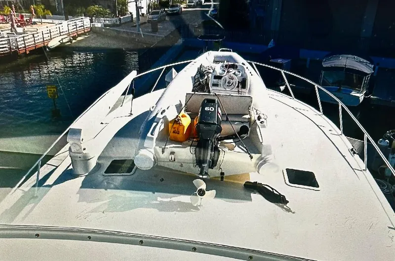 Slide: The Image of Viking 65 Convertible 2000 yacht with dinghy on deck, docked at marina. - 36