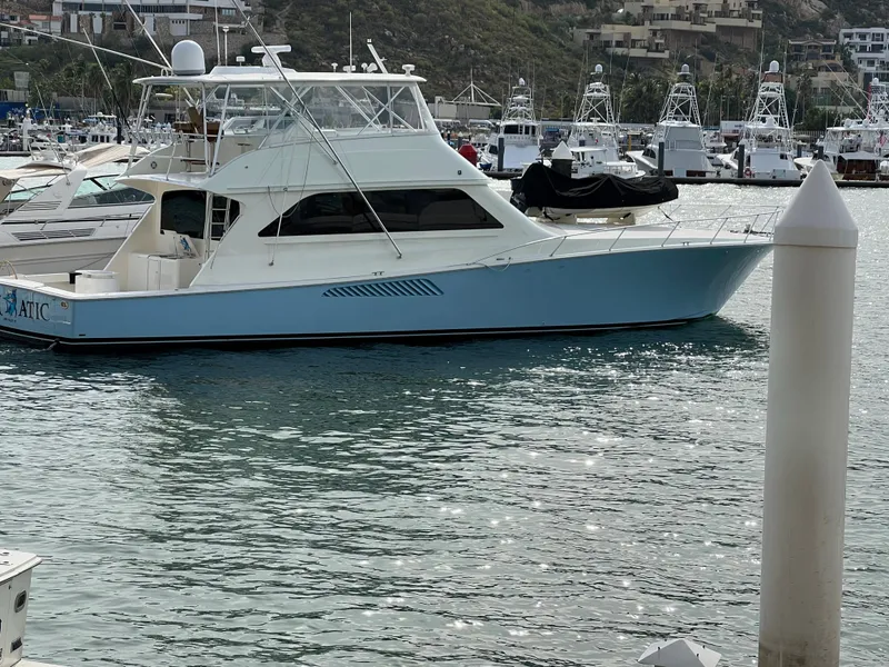 Slide: The Image of 2000 Viking 65 Convertible yacht docked in a marina, side view. - 5