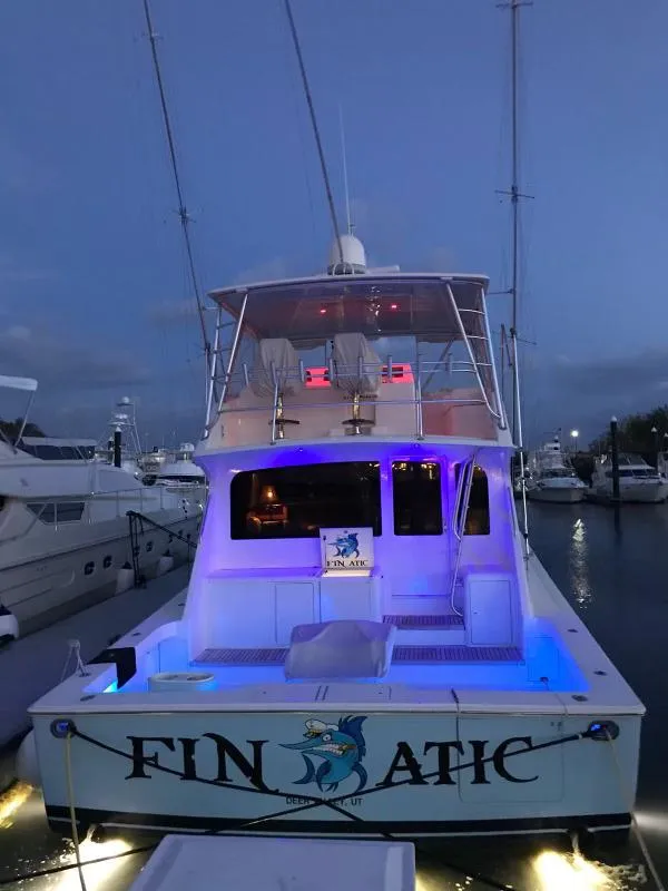 Slide: The Image of Viking 65 Convertible 2000 yacht "Finatic" docked with blue lights at dusk. - 7
