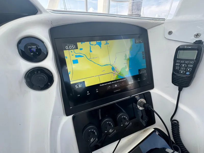 Slide: The Image of Control panel of a 2003 Deep Impact 36 Open boat with navigation screen and radio. - 16