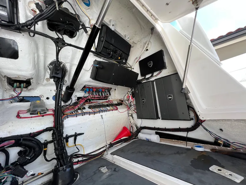 Slide: The Image of Interior view of a 2003 Deep Impact 36 Open boat, showcasing wiring and electronic components. - 17