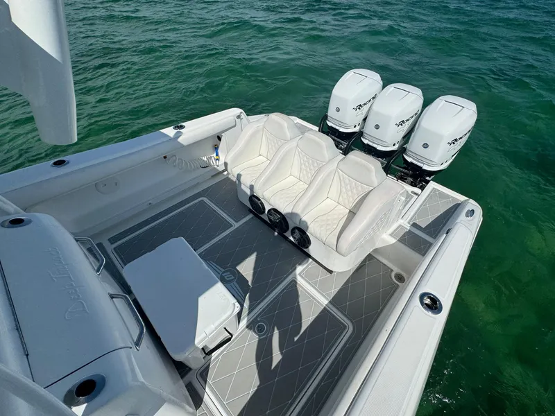 Slide: The Image of 2003 Deep Impact 36 Open boat with triple outboard engines on the water. - 19