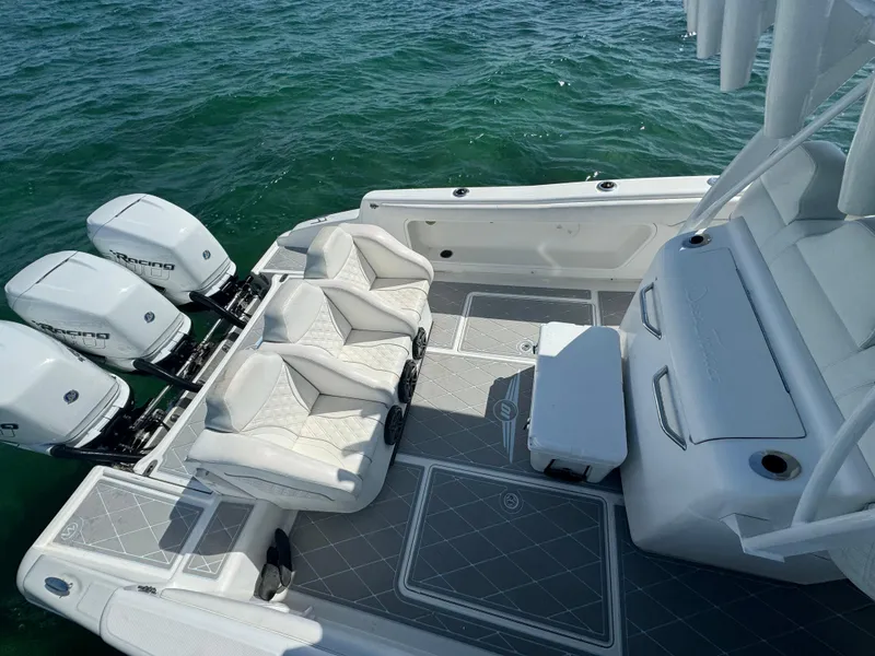 Slide: The Image of 2003 Deep Impact 36 Open boat with triple outboard engines on clear water. - 21