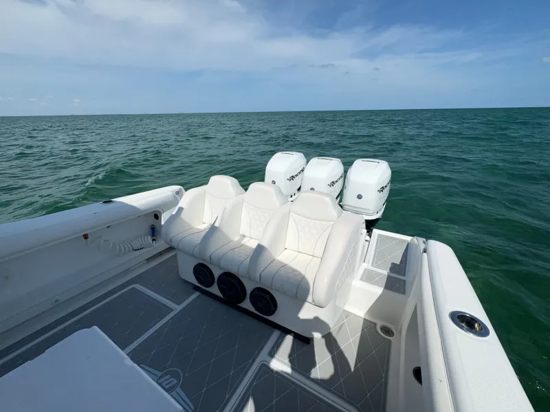 Slide: The Image of Deep Impact 36 Open 2003 boat with triple outboard engines on open water. - 22