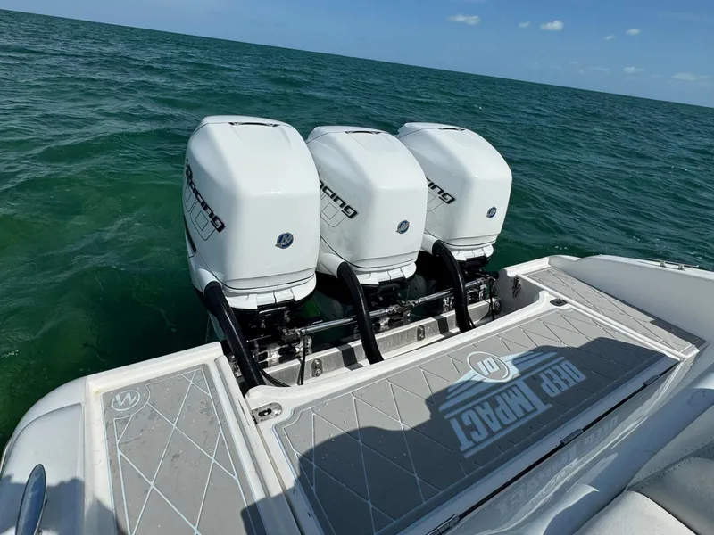 Slide: The Image of 2003 Deep Impact 36 Open boat with triple outboard engines on the water. - 23