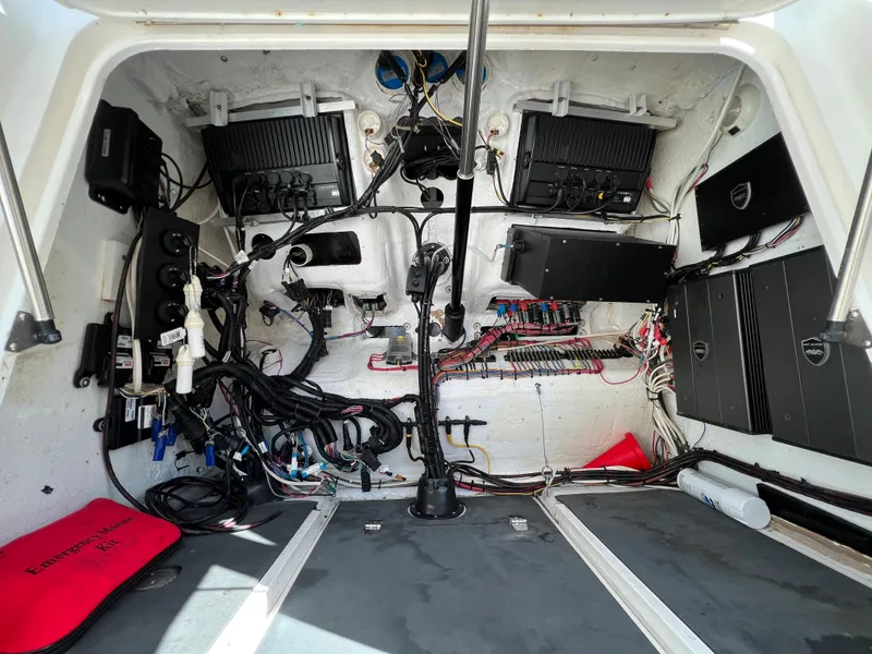 Slide: The Image of Electrical system inside a 2003 Deep Impact 36 Open boat, showcasing wiring and components. - 26