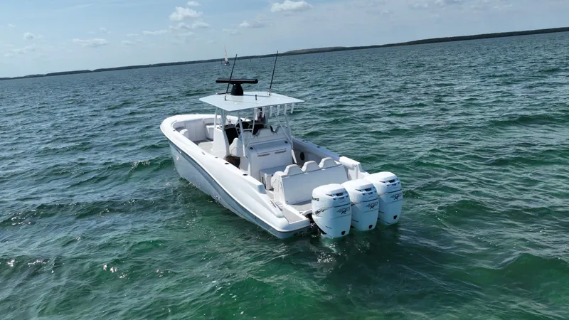 Slide: The Image of 2003 Deep Impact 36 Open boat with triple outboard engines on open water. - 5