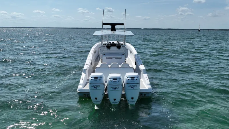 Slide: The Image of 2003 Deep Impact 36 Open boat with triple outboard engines on the water. - 6