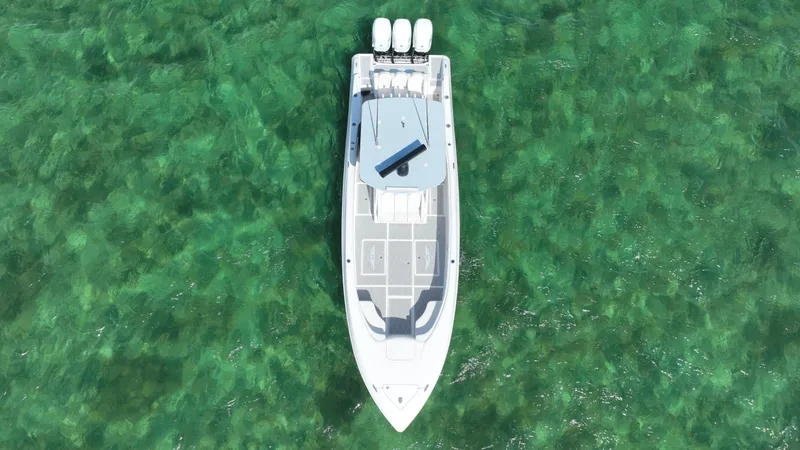 Slide: The Image of Aerial view of 2003 Deep Impact 36 Open boat on clear green water. - 8