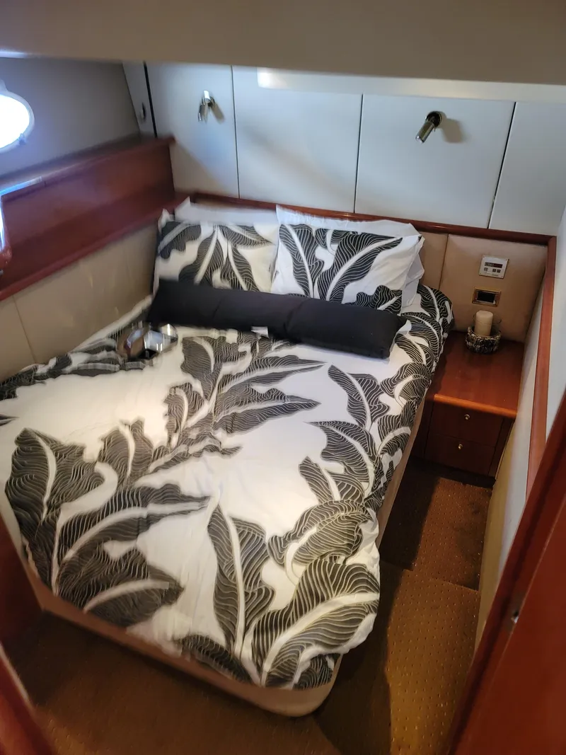 Slide: The Image of Interior of Sunseeker Predator 58 yacht, 2000 model, featuring cozy bedroom. - 26