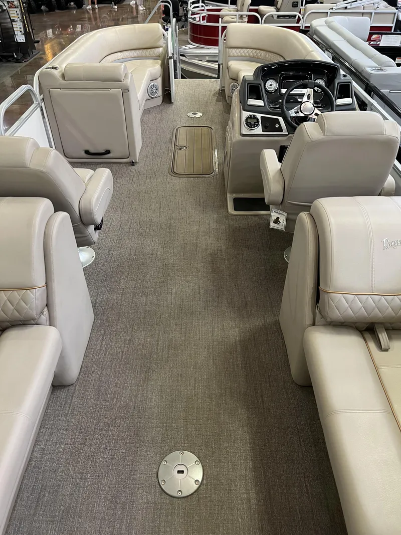 Slide: The Image of 2023 Ranger Reata 243C interior with beige seating and modern dashboard. - 7