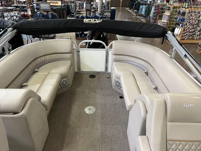 Slide: The Image of 2023 Ranger Reata 243C pontoon boat interior with beige seating. - 8