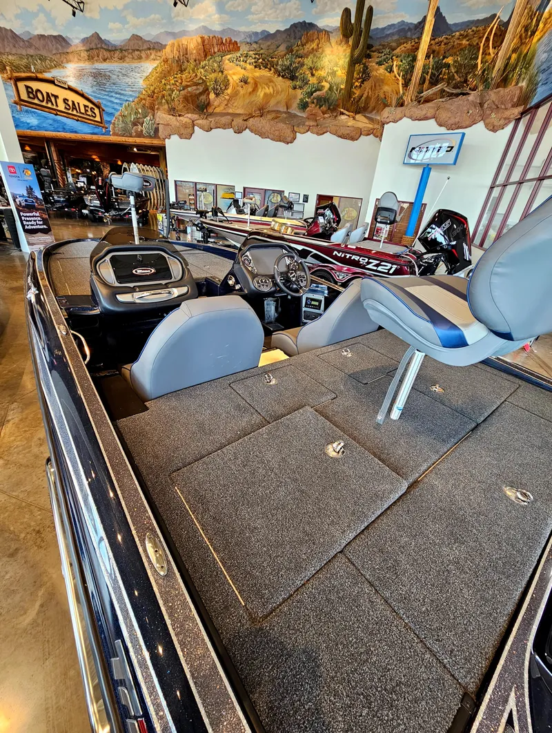 Slide: The Image of 2023 Triton 20 TRX boat on display at a boat sales showroom. - 3