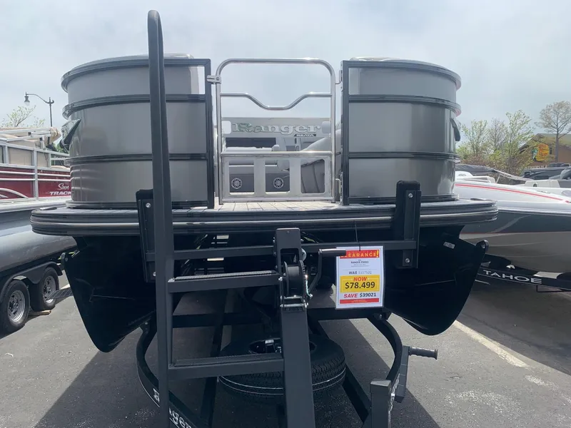 Slide: The Image of 2023 Ranger 2500LS pontoon boat on display with price tag, parked outdoors. - 3