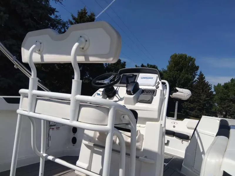 Slide: The Image of 2023 Tahoe 2150 CC boat interior with steering console and seating. - 3