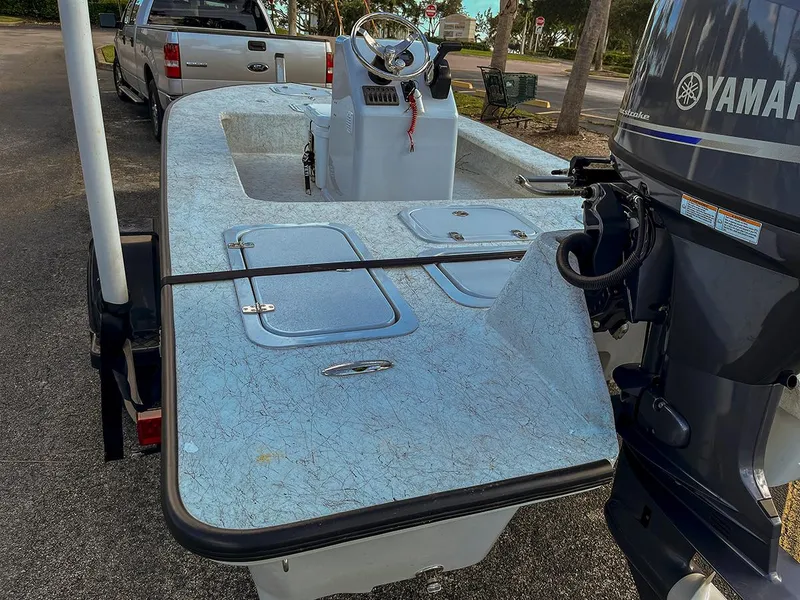 The Image of 2022 Bossman 17 Flats Boat with Yamaha engine, parked on a trailer. - 0