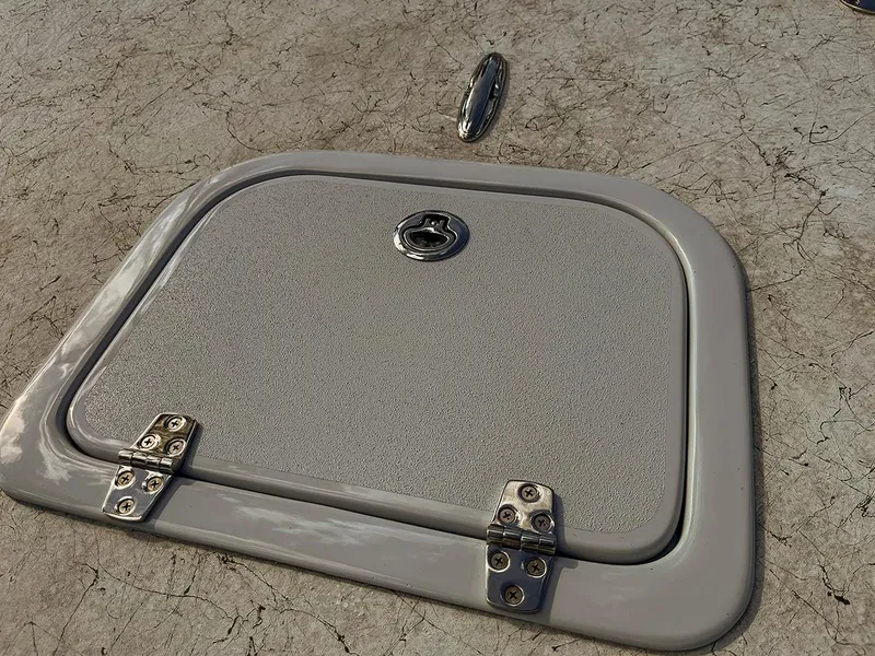 Slide: The Image of Hatch on 2022 Bossman 17 Flats Boat, featuring sturdy hinges and textured surface. - 10