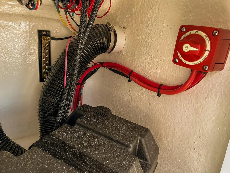 Slide: The Image of Electrical wiring and battery switch inside a 2022 Bossman 17 Flats Boat. - 15