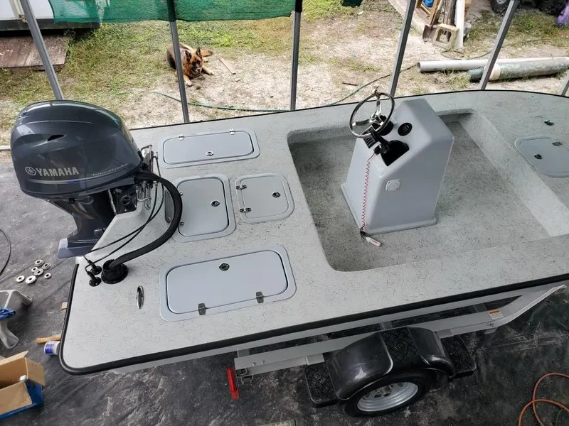 Slide: The Image of 2022 Bossman 17 Flats Boat with Yamaha engine, trailer, and control console. - 2