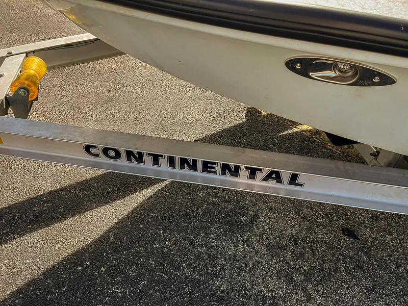 Slide: The Image of 2022 Bossman 17 Flats Boat on Continental trailer, parked on asphalt. - 9