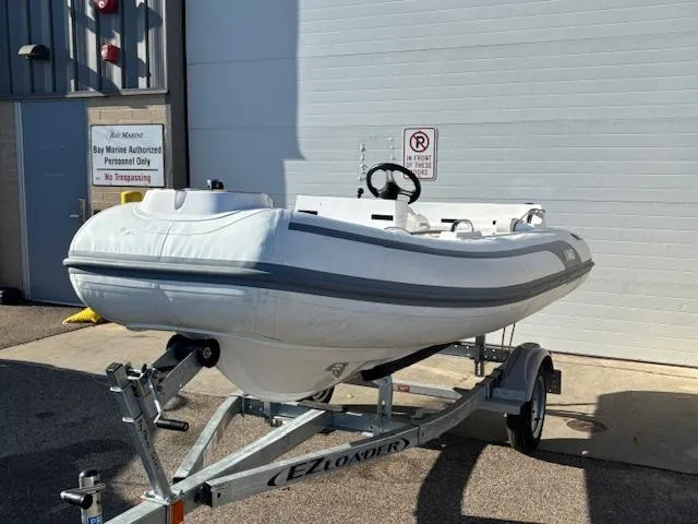 Slide: The Image of 2024 AB Inflatables ABJET 290 on trailer, parked outside a building. - 3