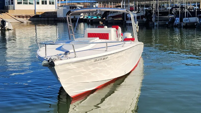 Slide: The Image of 2000 Marlago FS35 boat docked in marina, reflecting on calm water. - 40