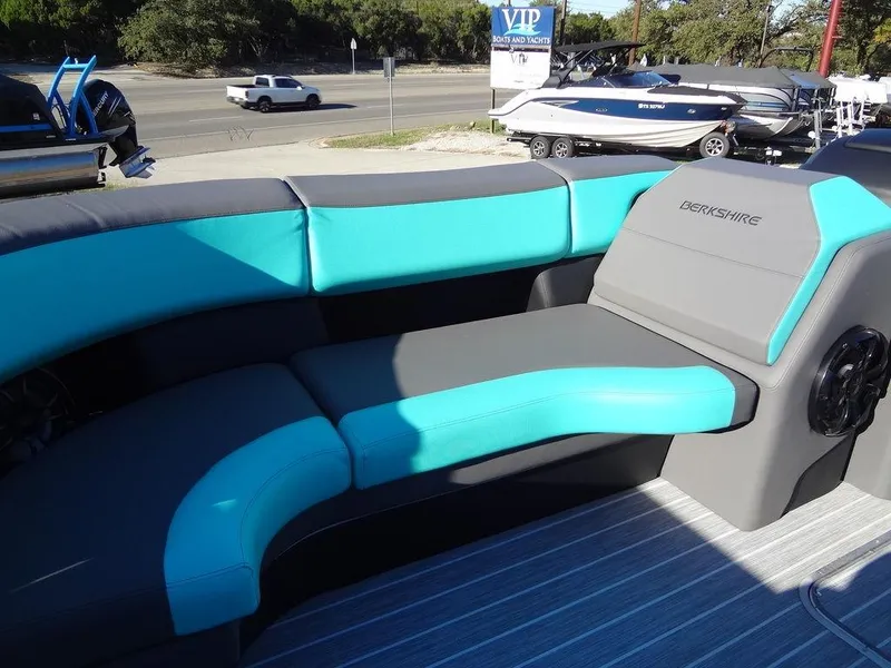 Slide: The Image of 2023 Berkshire 25RFX STS 3.0+ boat interior with teal and gray seating. - 16