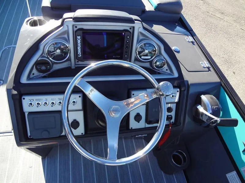 Slide: The Image of 2023 Berkshire 25RFX STS 3.0+ boat dashboard with steering wheel and control panel. - 31