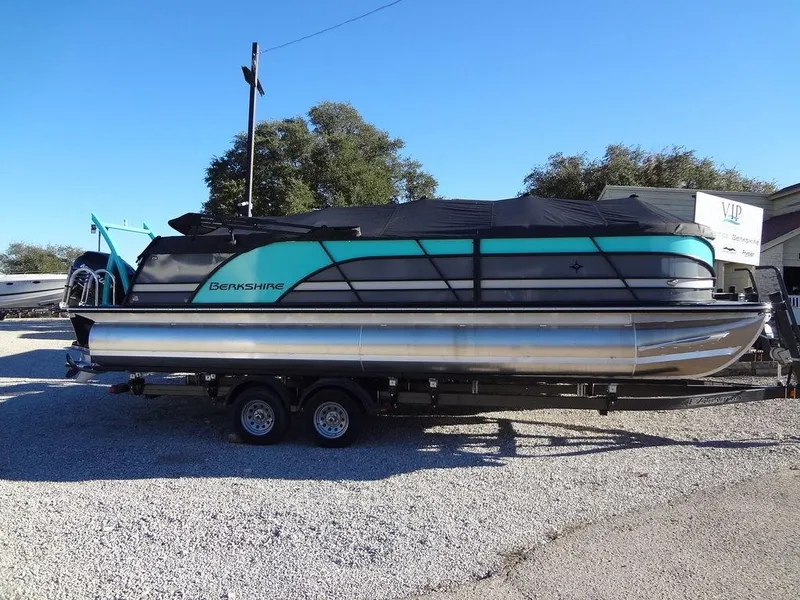 Slide: The Image of 2023 Berkshire 25RFX STS 3.0+ pontoon boat on trailer, covered and parked outdoors. - 4